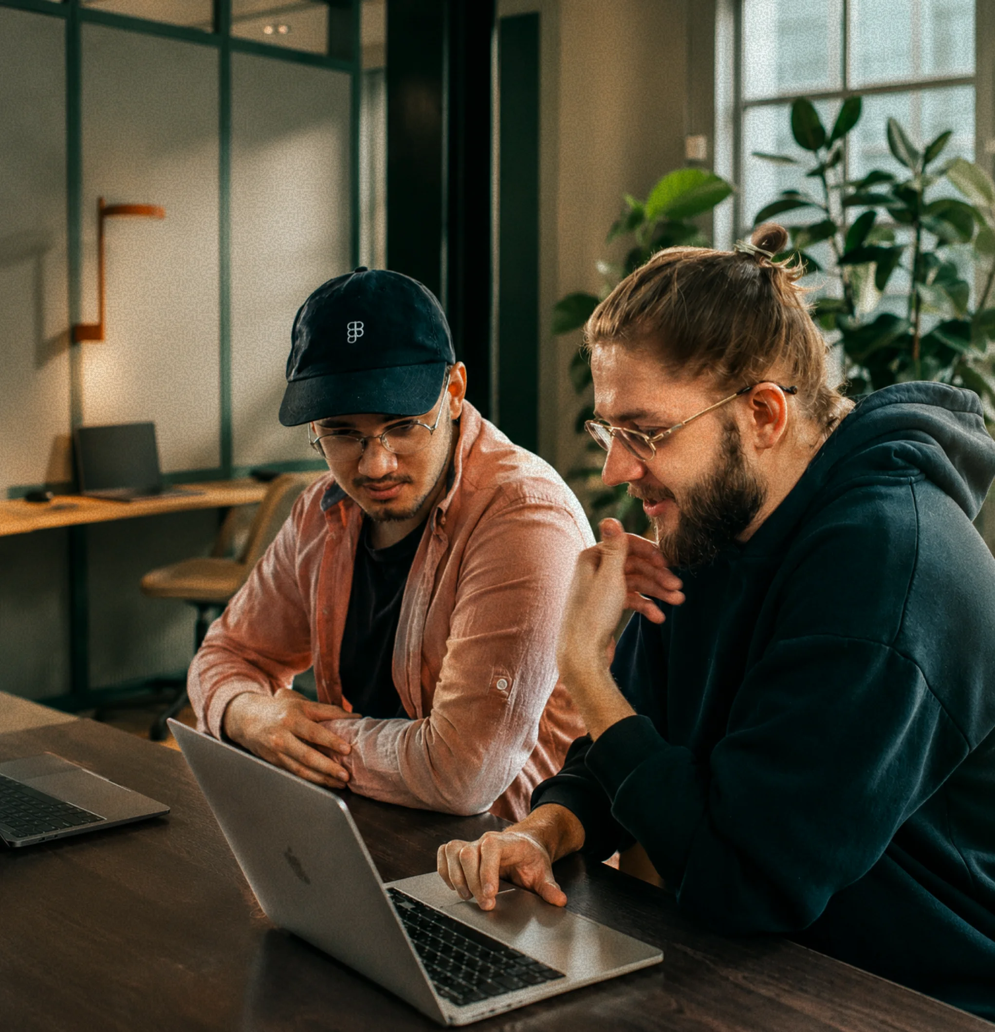 Two Coupler.io customers working together at a laptop